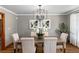 Dining room featuring a wood table with seating, neutral walls, and sophisticated light fixture at 730 Crescent Ln, Lakewood, CO 80214