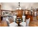 Open-concept dining and living room area with hardwood floors and lots of natural light at 730 Crescent Ln, Lakewood, CO 80214