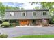 Charming home featuring a stone facade, unique roof, and manicured lawn, creating a welcoming curb appeal at 730 Crescent Ln, Lakewood, CO 80214