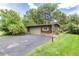 A matching shed with garage door, stone accents and basketball court on asphalt driveway at 730 Crescent Ln, Lakewood, CO 80214