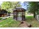 Backyard gazebo on a landscaped lot featuring charming design elements and serene garden views at 730 Crescent Ln, Lakewood, CO 80214