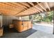 A private hot tub area under a covered deck, set in a tranquil outdoor setting, perfect for relaxation at 730 Crescent Ln, Lakewood, CO 80214