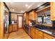 Well-lit kitchen with wood cabinets, granite countertops, stainless steel appliances and hardwood floors at 730 Crescent Ln, Lakewood, CO 80214