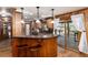 Kitchen with wood cabinets, granite countertops, and stainless steel appliances next to a breakfast bar at 730 Crescent Ln, Lakewood, CO 80214