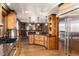 Spacious kitchen with stainless steel refrigerator, granite countertops and wood cabinets at 730 Crescent Ln, Lakewood, CO 80214