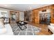 Spacious living room with hardwood floors, a stone fireplace, and French doors leading to other rooms at 730 Crescent Ln, Lakewood, CO 80214