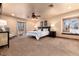 Large bedroom with carpet, large windows, a ceiling fan and neutral decor at 730 Crescent Ln, Lakewood, CO 80214