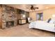 Spacious bedroom featuring a stone fireplace, a ceiling fan and a comfortable sitting area at 730 Crescent Ln, Lakewood, CO 80214