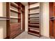 Spacious walk-in closet with custom wood shelving and drawers providing ample storage space at 730 Crescent Ln, Lakewood, CO 80214