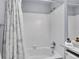 Bathroom with a bathtub and shower features white tiling and a decorative shower curtain at 1101 Ridgeview Cir, Broomfield, CO 80020