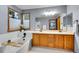 Bathroom featuring a corner tub, double vanity and large mirror at 1101 Ridgeview Cir, Broomfield, CO 80020