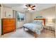 Cozy bedroom features wood furniture, a ceiling fan, and a window view at 1101 Ridgeview Cir, Broomfield, CO 80020