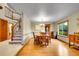 Bright dining room with hardwood floors, staircase, and natural light at 1101 Ridgeview Cir, Broomfield, CO 80020