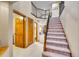 Welcoming foyer with staircase, wood doors, and access to multiple rooms at 1101 Ridgeview Cir, Broomfield, CO 80020