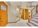 Inviting foyer with a decorative front door, light tile flooring, and staircase to the upper level at 1101 Ridgeview Cir, Broomfield, CO 80020