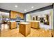 Bright kitchen with oak cabinets, central island, stainless steel appliances, and hardwood floors at 1101 Ridgeview Cir, Broomfield, CO 80020