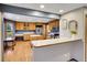 Well-lit kitchen with wooden cabinets, stainless steel appliances, a center island, and an inviting breakfast bar at 1101 Ridgeview Cir, Broomfield, CO 80020