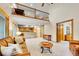 Spacious living room with a loft view, light-colored carpet, and access to the kitchen, offering a comfortable layout at 1101 Ridgeview Cir, Broomfield, CO 80020