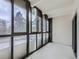 Empty balcony with a view, hardwood floors, and white brick wall at 800 Pearl St # 204, Denver, CO 80203