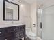 Modern bathroom featuring a dark wood vanity, marble countertop, toilet, and glass door shower at 800 Pearl St # 204, Denver, CO 80203