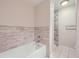 Cozy bathroom featuring a bathtub and walk-in shower with neutral tile at 800 Pearl St # 204, Denver, CO 80203