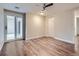 Bedroom featuring sliding glass doors, wood floors and bright white walls at 800 Pearl St # 204, Denver, CO 80203