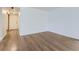 Empty bedroom with hardwood floors and a view into the doorway; all in neutral colors at 800 Pearl St # 204, Denver, CO 80203