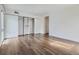 Neutral bedroom with hardwood floors, a large closet, and a door to the patio at 800 Pearl St # 204, Denver, CO 80203