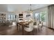 Dining room with a table set for six, views of the balcony, and an open view to the living room at 800 Pearl St # 204, Denver, CO 80203