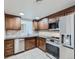 Well-lit kitchen with wooden cabinets, modern appliances and neutral colored backsplash and countertops at 800 Pearl St # 204, Denver, CO 80203