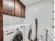 Practical laundry room with modern washer and dryer and lots of storage space at 800 Pearl St # 204, Denver, CO 80203