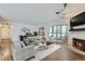 Bright living room with modern furnishings, fireplace and a sliding glass door to the balcony at 800 Pearl St # 204, Denver, CO 80203