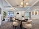 Clubhouse lounge area with card tables, comfortable seating, fireplace, and slider to an exterior patio at 800 Pearl St # 204, Denver, CO 80203