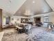 Open clubhouse and lounge area with a long table, multiple seating arrangements, and neutral carpeting at 800 Pearl St # 204, Denver, CO 80203