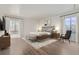 Spacious main bedroom with hardwood floors, large windows, and modern decor at 800 Pearl St # 204, Denver, CO 80203