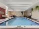 Indoor pool area with tiled deck, brick walls, and ample natural light at 800 Pearl St # 204, Denver, CO 80203
