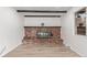 Living room with brick fireplace and hardwood floors at 8736 E Easter Ave, Centennial, CO 80112