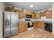 Modern kitchen features stainless steel appliances and light wood cabinets at 8979 Field St # 21, Broomfield, CO 80021