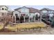 Large backyard with a multi-level deck, stone pillars, and a charming water feature at 1015 Graland Pl, Highlands Ranch, CO 80126