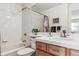 Bright bathroom featuring a shower, bathtub, and a white vanity with tiled counterspace at 1015 Graland Pl, Highlands Ranch, CO 80126