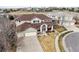 Two-story home featuring a three-car garage, manicured front yard, and welcoming entrance from an aerial view at 1015 Graland Pl, Highlands Ranch, CO 80126