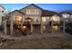 Rear exterior showcasing a large home with a multi-level deck and a lush backyard at 1015 Graland Pl, Highlands Ranch, CO 80126