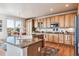 Spacious kitchen features granite countertops, wood cabinets, stainless steel appliances, and a functional island at 1015 Graland Pl, Highlands Ranch, CO 80126