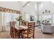 Open-concept living and dining area featuring high ceilings, neutral tones, and large windows with sunlight at 1015 Graland Pl, Highlands Ranch, CO 80126