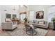 Bright living room with high ceilings, neutral furniture, and a dining area bathed in natural light at 1015 Graland Pl, Highlands Ranch, CO 80126
