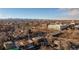 Wide aerial view of a neighborhood with a city skyline and distant mountains at 1074 Knox Ct, Denver, CO 80204