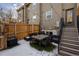 Well-maintained backyard with outdoor dining set, string lights, and wooden fence at 1074 Knox Ct, Denver, CO 80204