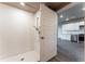 Modern bathroom with walk-in shower and kitchen view at 12983 W Ida Ave # 408, Littleton, CO 80127