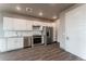 Modern kitchen with white shaker cabinets and stainless steel appliances at 12983 W Ida Ave # 408, Littleton, CO 80127