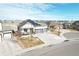 Modern home with solar panels and large driveway, viewed from above at 21589 E Union Pl, Aurora, CO 80015